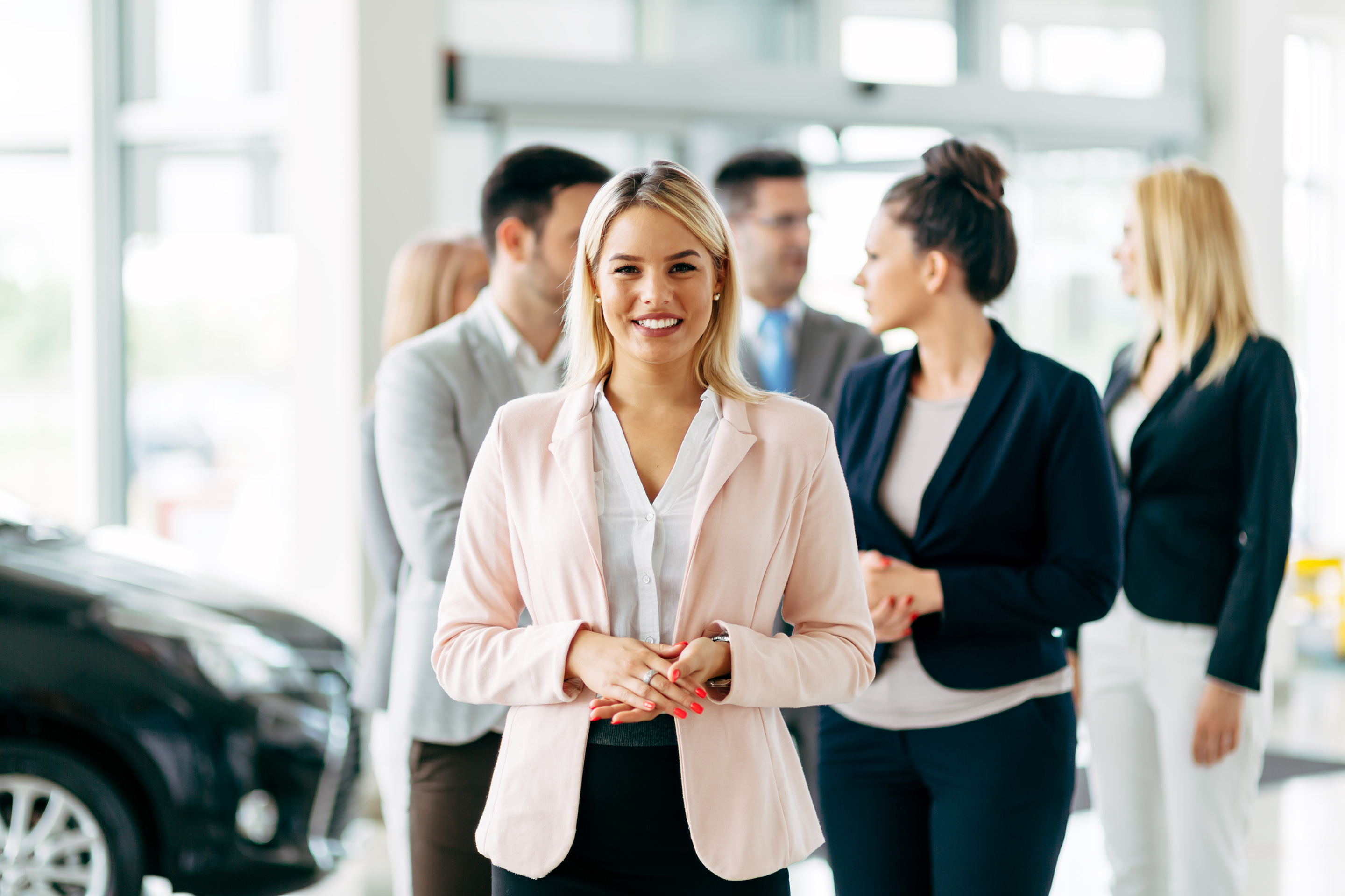 Autohaus Website professional woman smiles among colleagues inside 2026 03 24 07 44 00 utc